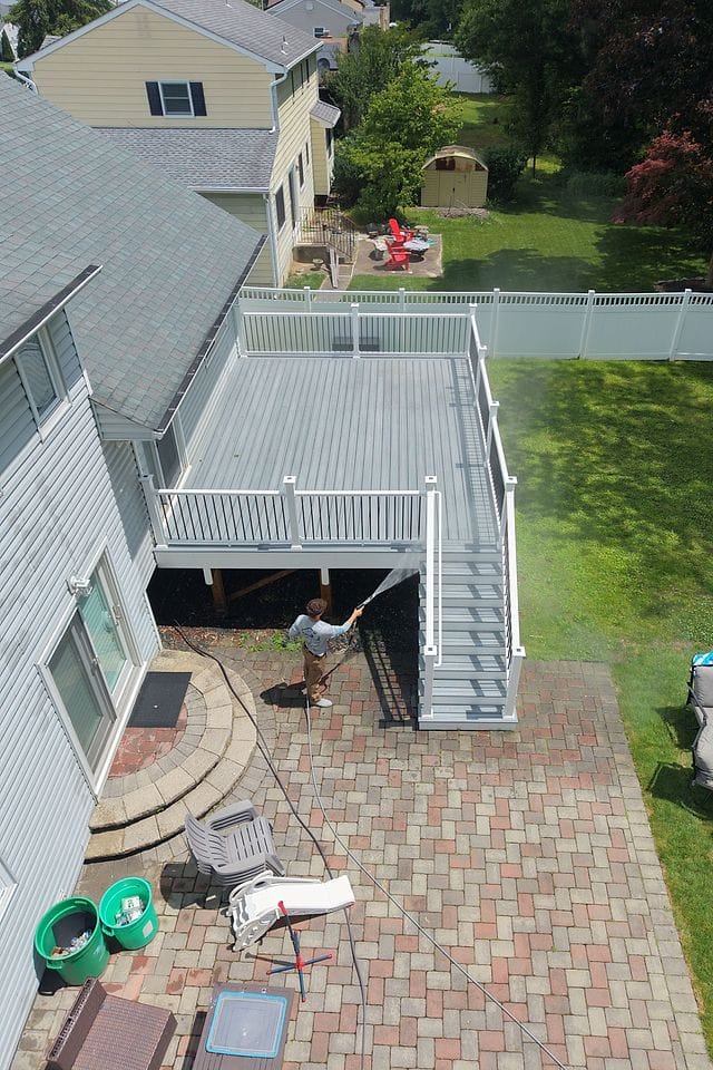 Drone view of a rear deck and its stairs being washed down