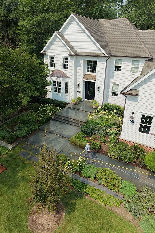 Drone view of a slate front walkway being washed clean